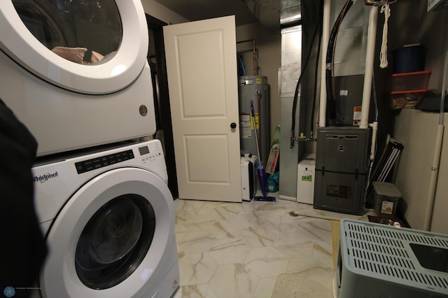 washroom with stacked washer and dryer and electric water heater