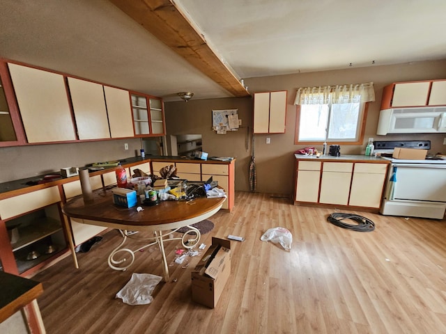 kitchen with white appliances and light hardwood / wood-style flooring