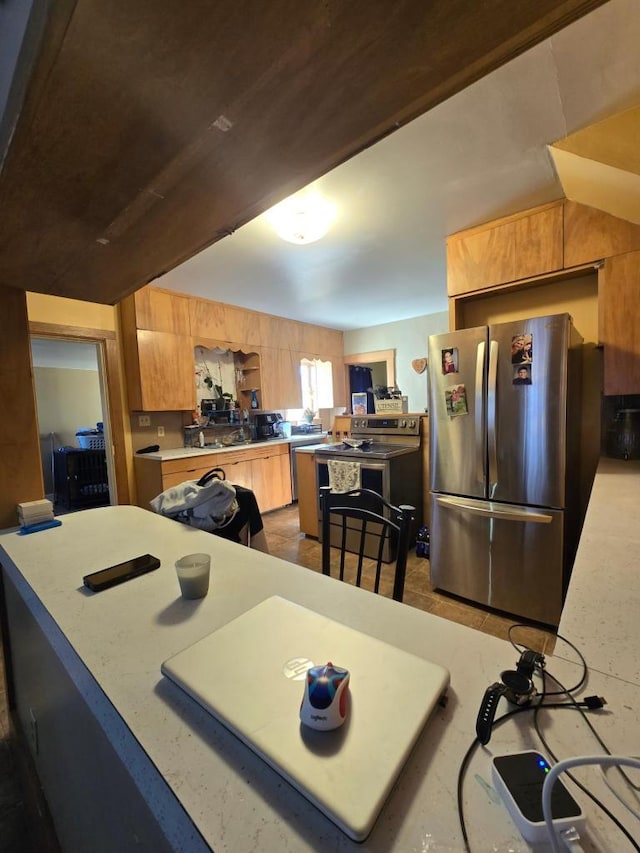 kitchen with stainless steel fridge and lofted ceiling