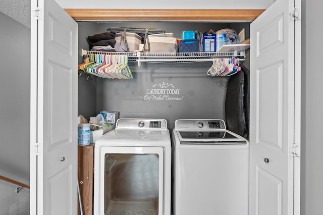 laundry room featuring a textured ceiling and washer and clothes dryer