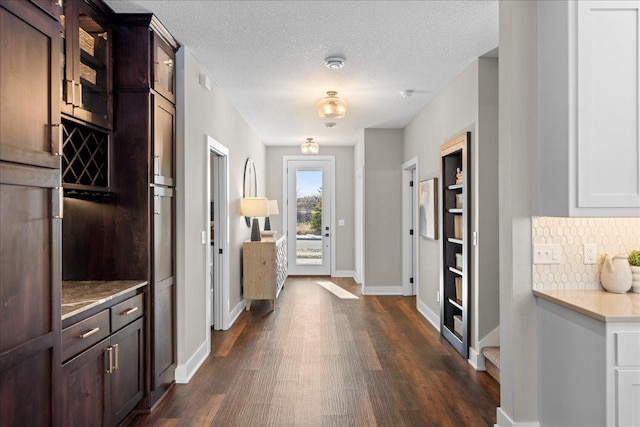 kitchen featuring tasteful backsplash, white cabinetry, dark brown cabinets, and dark hardwood / wood-style flooring