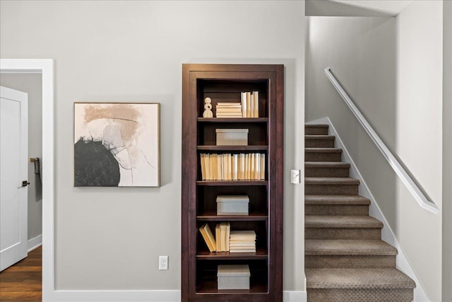 stairs with hardwood / wood-style flooring