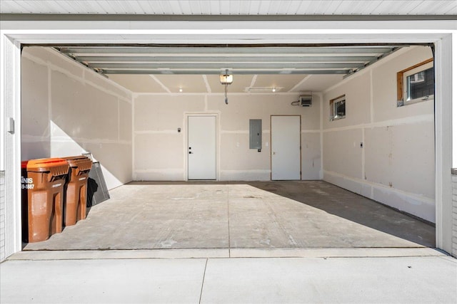 garage with a garage door opener and electric panel