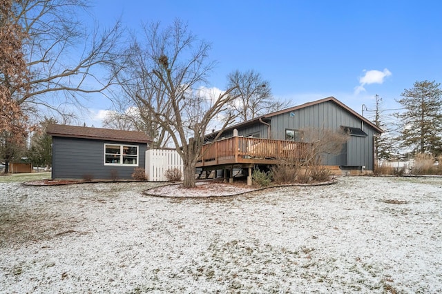 snow covered house with a deck