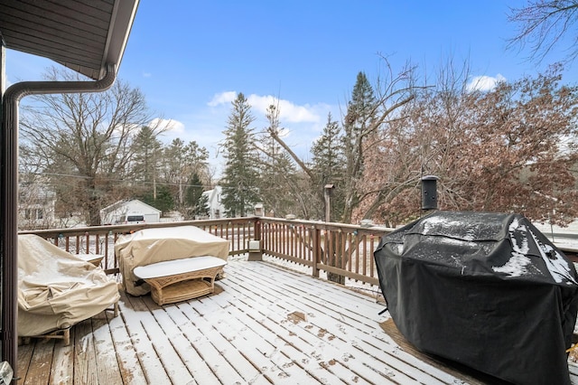 snow covered deck featuring a grill