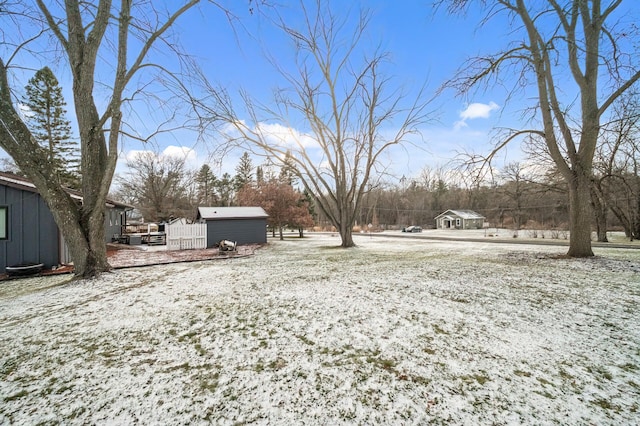 yard covered in snow with a storage unit