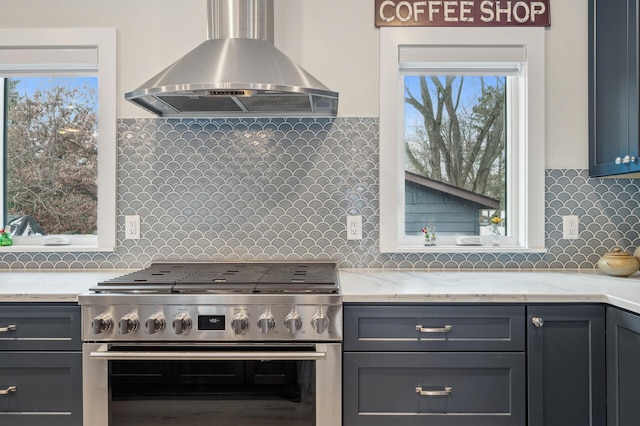 kitchen featuring ventilation hood, gas stove, plenty of natural light, and tasteful backsplash