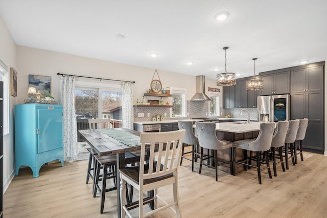 dining area with sink and light hardwood / wood-style flooring