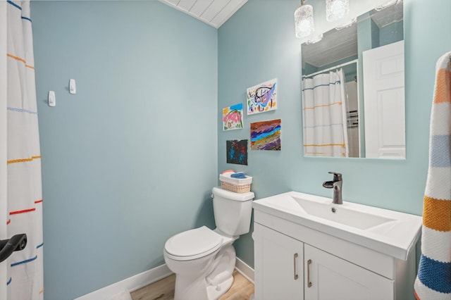 bathroom featuring vanity, toilet, and wood-type flooring