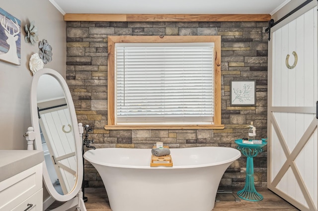 bathroom featuring crown molding, a bathtub, and wood-type flooring