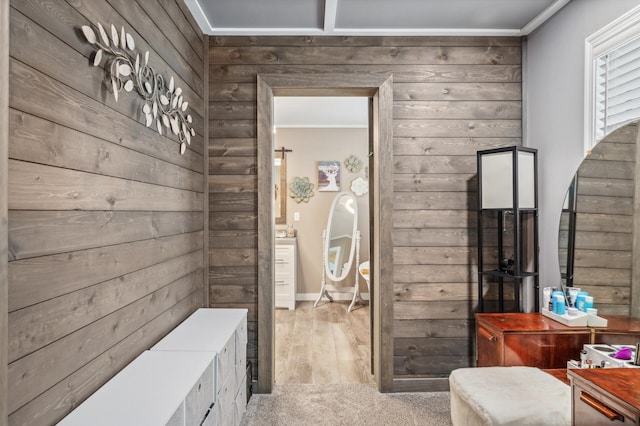 bathroom featuring crown molding and wood walls