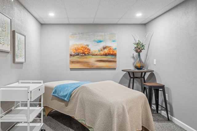 carpeted bedroom featuring a paneled ceiling