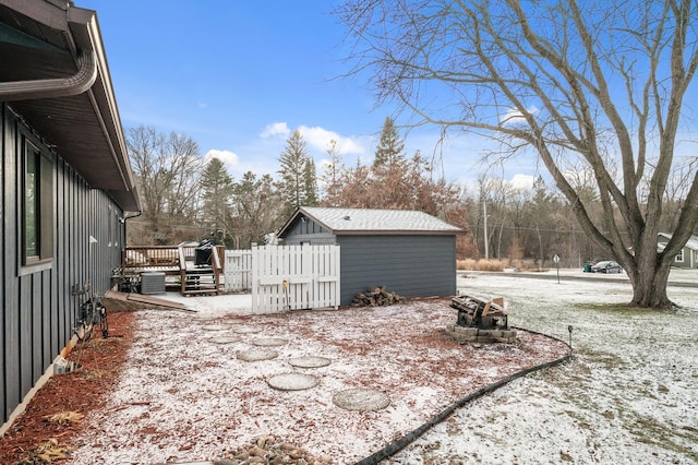 snow covered patio with a deck