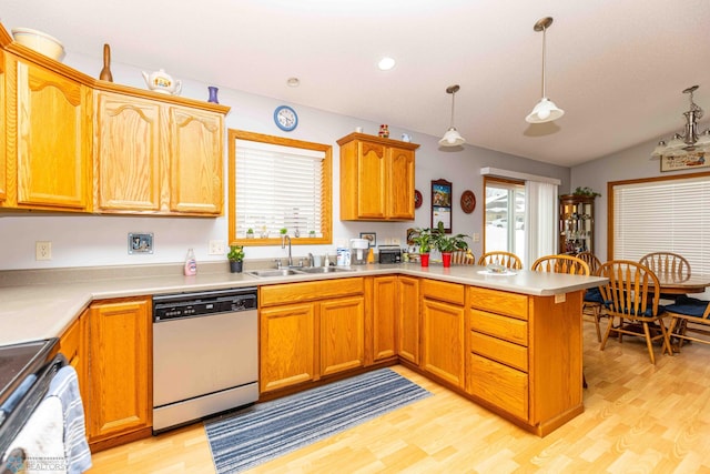 kitchen featuring white dishwasher, pendant lighting, and light hardwood / wood-style flooring