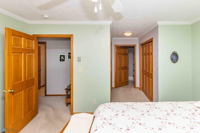 carpeted bedroom with ceiling fan, a closet, a textured ceiling, and ornamental molding