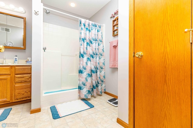 bathroom with tile patterned flooring and vanity