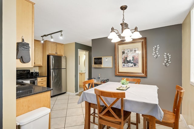 5136 Hiawatha Ave Unit 002, Minneapolis, MN 55417 - dining space featuring baseboards, rail lighting, light tile patterned floors, and a notable chandelier