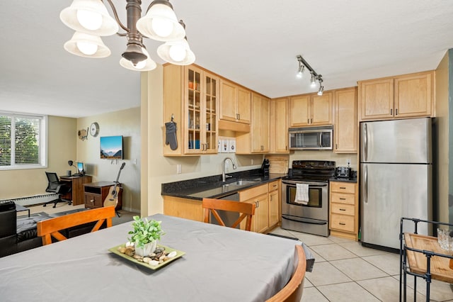 5136 Hiawatha Ave Unit 002, Minneapolis, MN 55417 - kitchen featuring light brown cabinetry, a baseboard heating unit, a chandelier, a sink, and appliances with stainless steel finishes