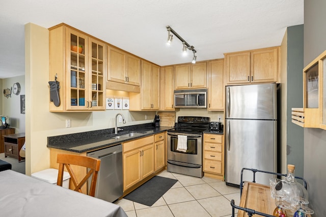 5136 Hiawatha Ave Unit 002, Minneapolis, MN 55417 - kitchen featuring a sink, appliances with stainless steel finishes, light tile patterned flooring, and glass insert cabinets