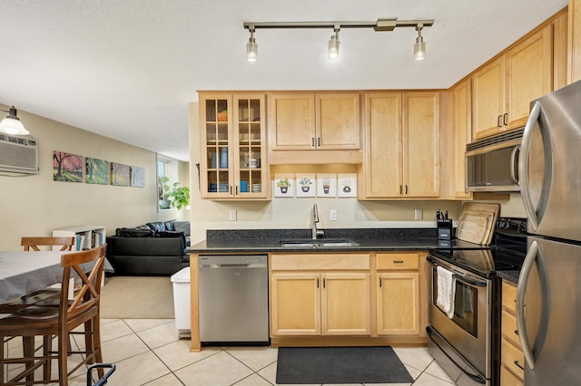 5136 Hiawatha Ave Unit 002, Minneapolis, MN 55417 - kitchen with a sink, appliances with stainless steel finishes, light brown cabinets, and light tile patterned flooring