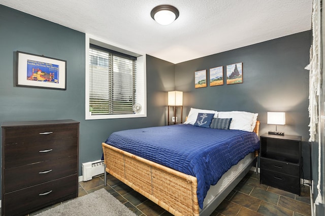 5136 Hiawatha Ave Unit 002, Minneapolis, MN 55417 - bedroom featuring a textured ceiling and a baseboard radiator