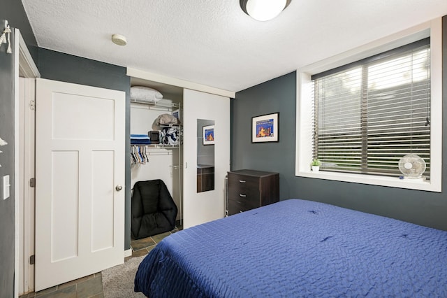 5136 Hiawatha Ave Unit 002, Minneapolis, MN 55417 - bedroom with a closet, a textured ceiling, and tile patterned flooring