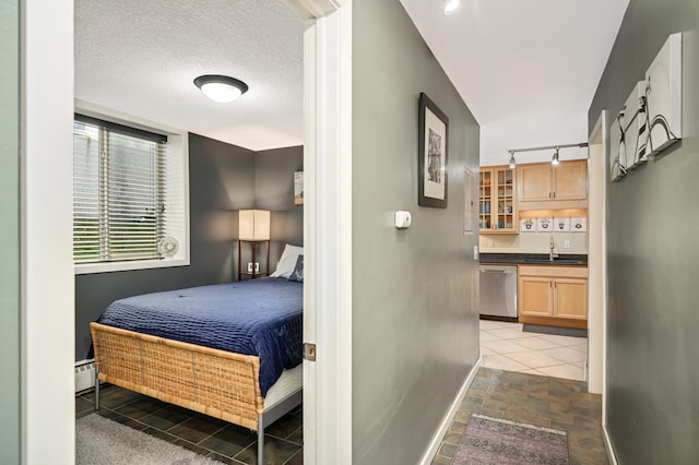 5136 Hiawatha Ave Unit 002, Minneapolis, MN 55417 - bedroom with baseboards, indoor wet bar, baseboard heating, stone finish floor, and a sink