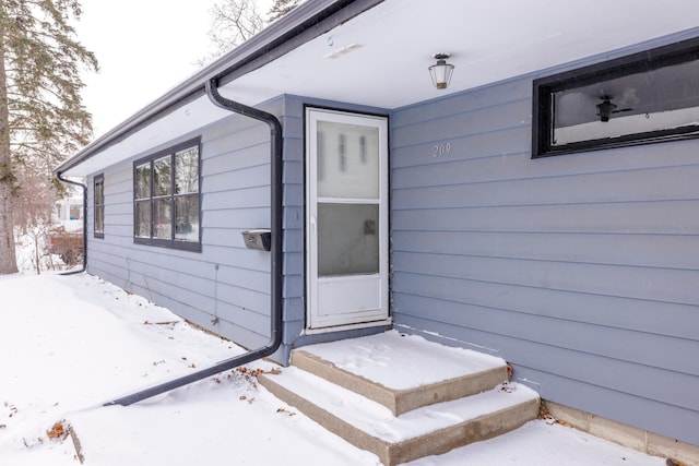 view of snow covered property entrance