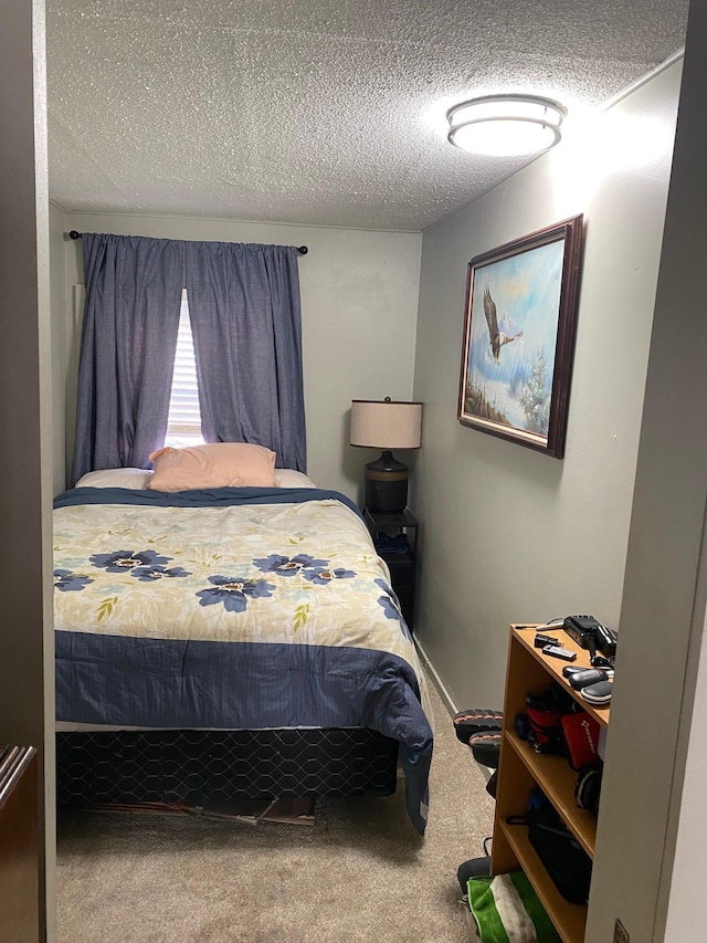 carpeted bedroom featuring a textured ceiling