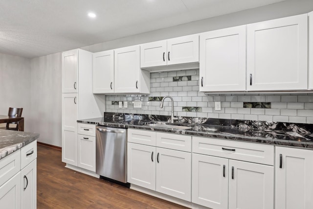 kitchen featuring dishwasher, dark stone counters, white cabinets, sink, and dark hardwood / wood-style floors