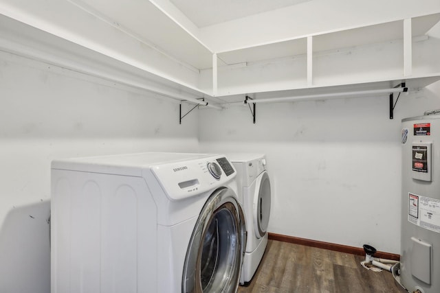 laundry room with independent washer and dryer, dark wood-type flooring, and water heater