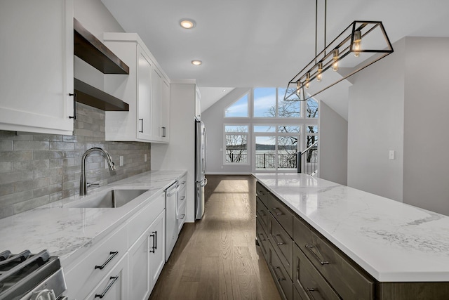 kitchen with white cabinetry, sink, hanging light fixtures, and dark wood-type flooring