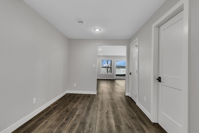 hallway with dark wood-type flooring