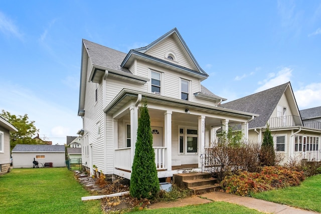 view of front of home with covered porch and a front yard