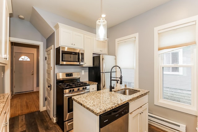 kitchen featuring white cabinetry, sink, stainless steel appliances, baseboard heating, and a center island with sink