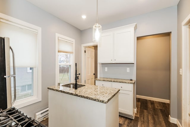 kitchen with light stone countertops, refrigerator, pendant lighting, white cabinets, and dark hardwood / wood-style floors