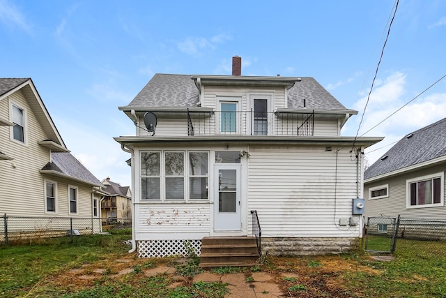 back of property with a balcony