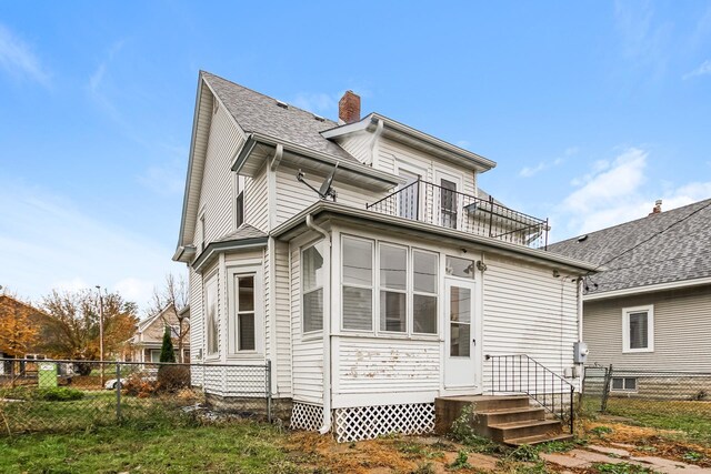 back of house with a balcony