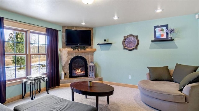 carpeted living room with a tiled fireplace