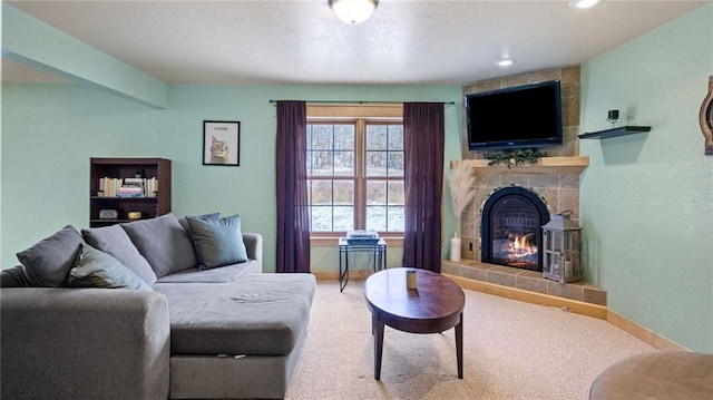 living room with carpet and a tiled fireplace