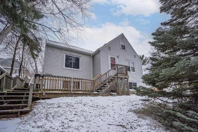 snow covered property with a deck