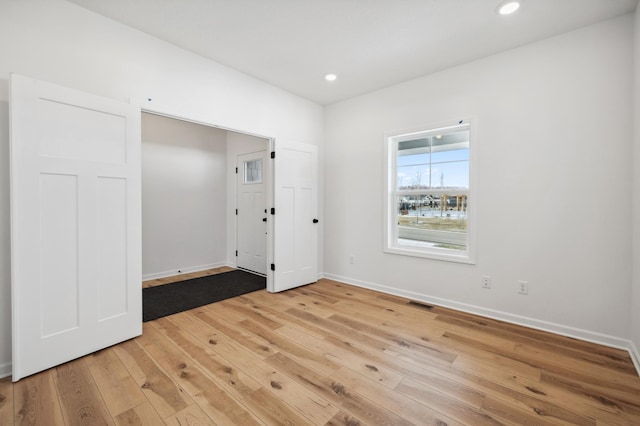 unfurnished room with light hardwood / wood-style flooring