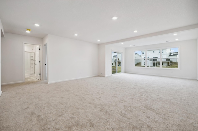 unfurnished living room featuring light colored carpet