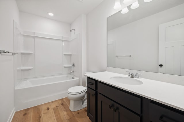 full bathroom with wood-type flooring, tub / shower combination, vanity, and toilet