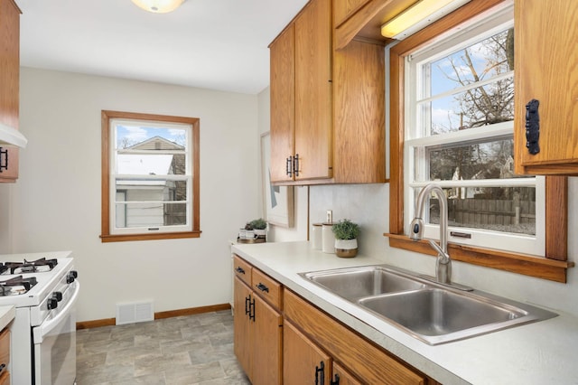 kitchen with sink and white range with gas stovetop