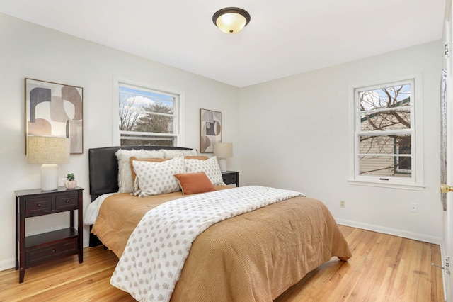 bedroom featuring light hardwood / wood-style floors and multiple windows