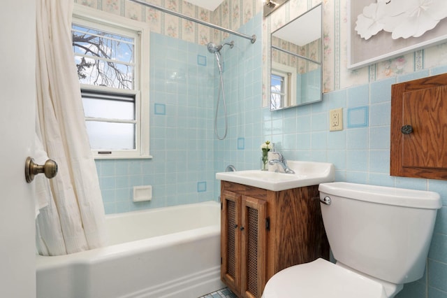 full bathroom with shower / tub combo with curtain, vanity, toilet, and tile walls