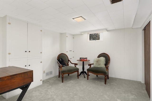 sitting room featuring light colored carpet