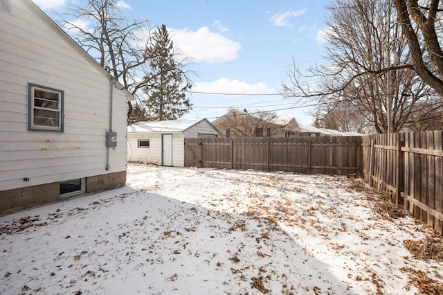 snowy yard with a shed