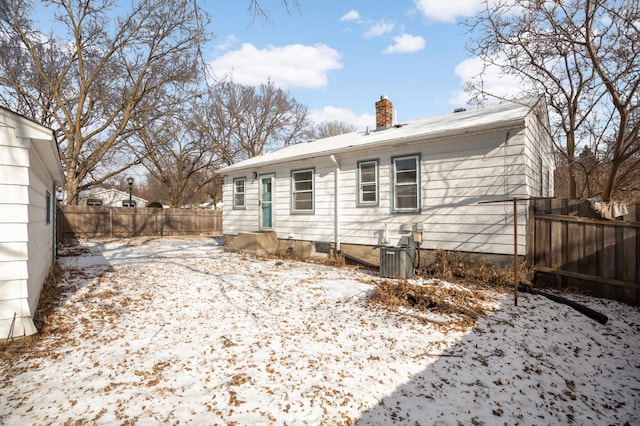 snow covered property featuring central air condition unit